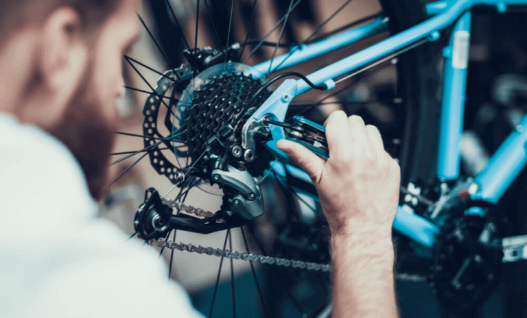 Bicycle mechanic working on a bicycle tire and spokes