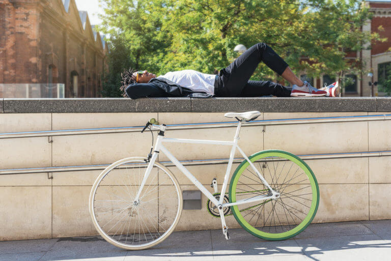 Man relaxing near his bicycle