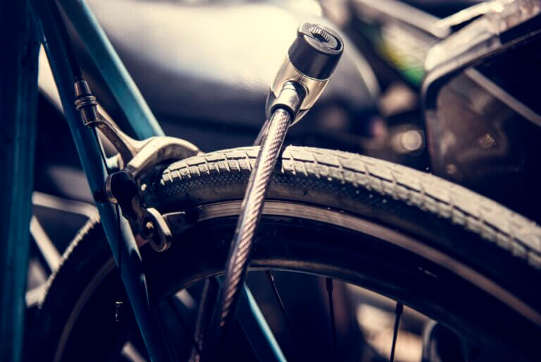 Close up of a bicycle tire with a lock around it