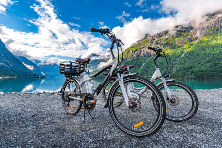 Two e-bikes parked on a beach