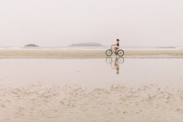 Woman riding her bicycle outdoors on the beach