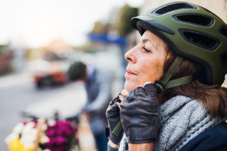 Woman wearing bicycle helmet and smiling