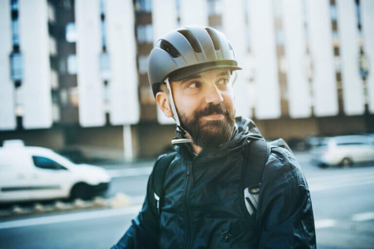 Man wearing bicycle helmet and smiling