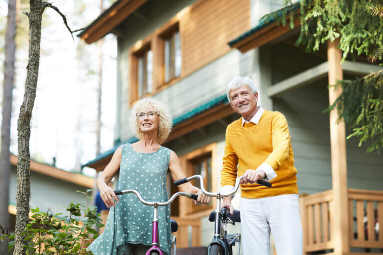Senior couple walking their bicycles