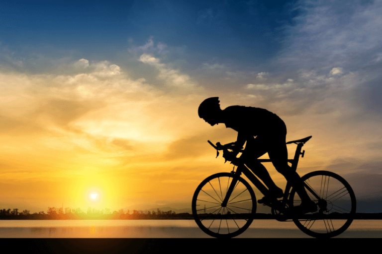 cyclist riding at sunset
