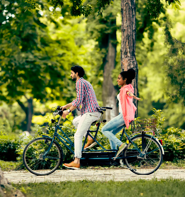 couple riding tandem bicycle
